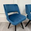 A glamorous Mid-Century dining chair with velvet upholstery and dark legs 