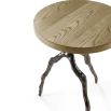 Light brown round top side table with branch-like bronze base