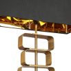 Table lamp with stacked brass shapes stem and rectangular black shade