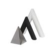 Overlapping stone and glass triangle sculptures