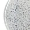 Curved vase with blue speckled effect