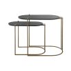 A glamorous set of nesting tables by Uttermost with oval tops and an antique brass finish