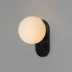 Black wall sconce with metal fixture and marbled glass bulb