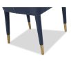 Blue velvet dining chair accented with golden-capped tapered legs