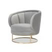 Grey velvet shapely chair with tubular brushed brass base and channelling