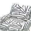 Square shaped lounge chair upholstered in black and white graphic print with brass legs