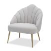 Light grey velvet chair with statement leaf backrest and tapered brass legs