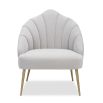 Light grey velvet chair with statement leaf backrest and tapered brass legs