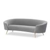 A stylish curved sofa by Liang & Eimil with a grey velvet upholstery and polished brass legs