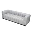 A luxury sofa by Liang & Eimil with a deep buttoned design and gorgeous grey upholstery