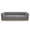 A stylish deep buttoned sofa with a gorgeous grey velvet upholstery and brushed brass base