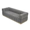 A stylish deep buttoned sofa with a gorgeous grey velvet upholstery and brushed brass base