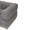 A stylish deep buttoned sofa with a gorgeous grey velvet upholstery and brushed brass base