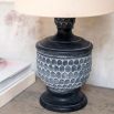 Side lamp resembling pine cone base, with cream linen shade