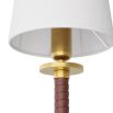 Classic wall sconce with red leather wrapped arm and brass mount