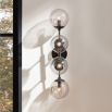 Wall sconce with four glass smoked globes feature lights fitting in a black frame