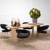 A natural oak table with a soft curved silhouette, complete with three thick legs