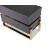 Brass legged bedside unit with brass accent in the middle and dark wood finish