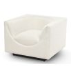 Sand chair with curvaceous tailoring in its dipped seat design