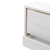 High gloss white lacquer chest of drawers with brass frame