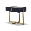 A sophisticated bedside table by Liang & Eimil with a black and brass finish