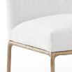 The Sloane Dining Chair, with its brass gold metal legs and off-white C0 fabric upholstery, effortlessly adds a chic mid-century modern touch to any dining space.