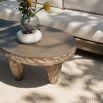 Kidney-shaped outdoor coffee table with smooth top and carved underside