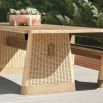 Rectangular teak dining table with two wide rattan legs and a supporting beam