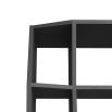 Geometric black wooden bookcase with shelving of varied depths
