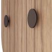 Curved wooden cabinet with ribbed, bronze-finish hardware