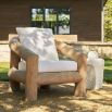 Outdoor dining chair with a thick wooden frame and white cushions