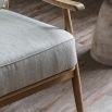 Chair with exposed wooden frame, padded seat and backrest upholstered in sleek linen