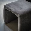 Curved armchair with squared footstool that slots underneath