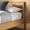 Stylish wooden kingsize bed with exposed corners