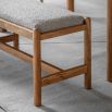 Slender wooden bench with boucle finish seat