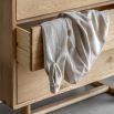 Stylish wooden chest of drawers with exposed corners