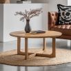 Round wooden coffee table with shaped underframe