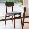 Retro inspired dining chair with grey fabric and walnut stained wooden frame