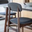 Retro inspired dining chair with grey fabric and walnut stained wooden frame