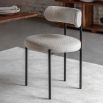 Round seat chair with slim legs and curved back