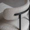 Round seat chair with slim legs and curved back