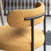 Round seat chair with slim legs and curved back