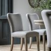 Upholstered curved dining chair with wooden legs