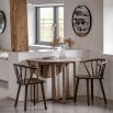 Folding circular wooden dining table with shaped underframe