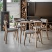 Round wooden dining table with four legs