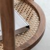 Circular wooden side table with lower rattan shelf