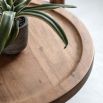 Circular wooden side table with lower rattan shelf