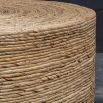 Round coffee table covered in natural rope weave