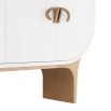 Four-door cabinet in crisp white lacquer with antique brass bullhorn-inspired hardware