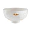 White bowl with lips detail and gold accents

